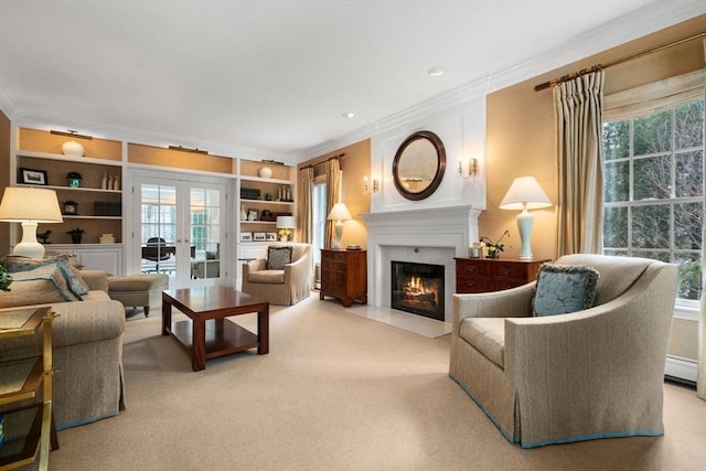 sitting room featuring french doors, a fireplace with flush hearth, carpet flooring, crown molding, and built in shelves