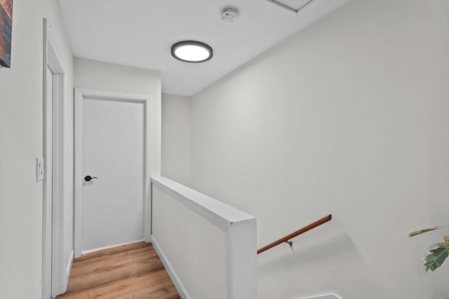 5257 Washington St Unit 5257, Boston, MA 02132 - corridor with light wood finished floors, an upstairs landing, and baseboards