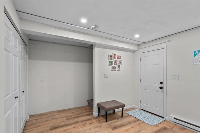 5257 Washington St Unit 5257, Boston, MA 02132 - entrance foyer with a baseboard radiator, light wood finished floors, and recessed lighting