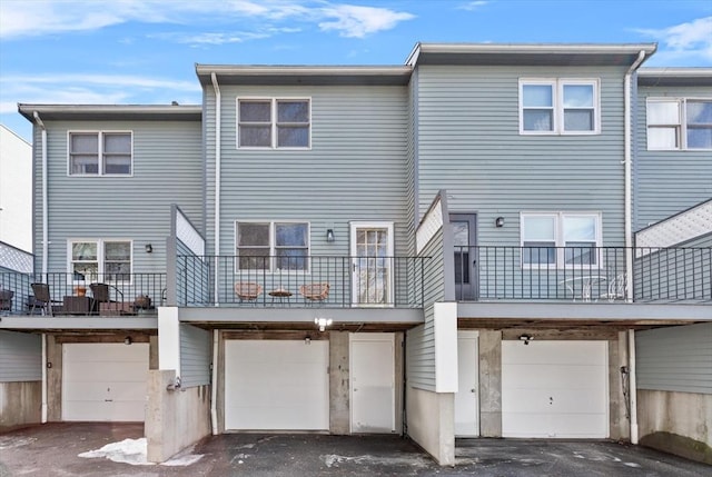 5257 Washington St Unit 5257, Boston, MA 02132 - rear view of property featuring an attached garage and driveway