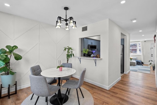 5257 Washington St Unit 5257, Boston, MA 02132 - dining area featuring light wood-style flooring, baseboards, recessed lighting, and a chandelier