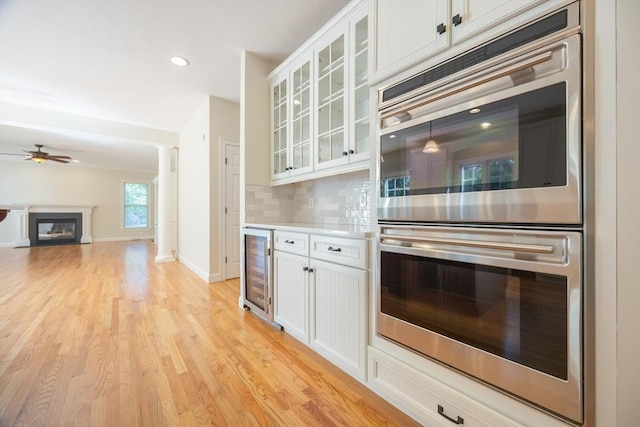 2 Pine Ridge Ln, Mattapoisett, MA 02739 - kitchen featuring stainless steel double oven, wine cooler, a ceiling fan, white cabinetry, and recessed lighting