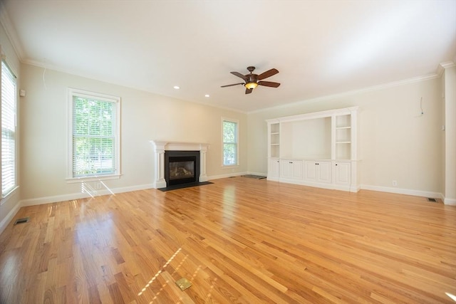 2 Pine Ridge Ln, Mattapoisett, MA 02739 - unfurnished living room featuring light wood finished floors, ceiling fan, a fireplace with flush hearth, baseboards, and crown molding