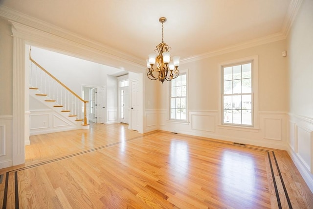 2 Pine Ridge Ln, Mattapoisett, MA 02739 - spare room featuring a chandelier, a decorative wall, stairway, light wood-style flooring, and wainscoting