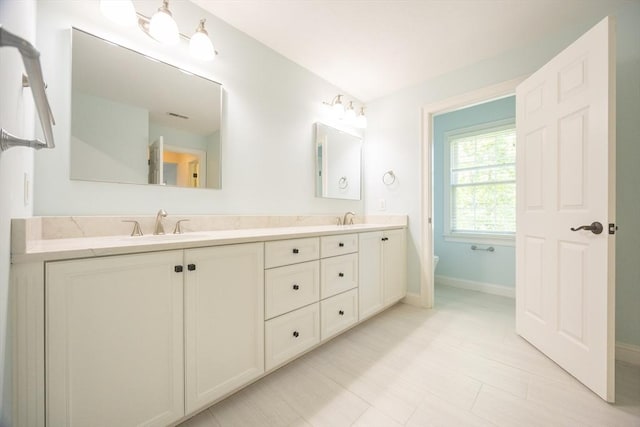2 Pine Ridge Ln, Mattapoisett, MA 02739 - bathroom with double vanity, baseboards, and toilet