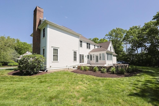 2 Pine Ridge Ln, Mattapoisett, MA 02739 - rear view of house featuring a chimney, a yard, and a patio