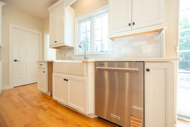 2 Pine Ridge Ln, Mattapoisett, MA 02739 - kitchen with dishwasher, a sink, backsplash, light wood-style flooring, and light countertops