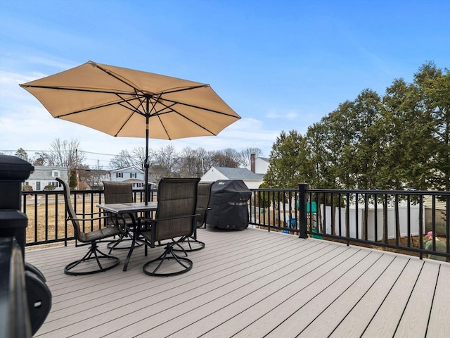 deck featuring outdoor dining space and a grill