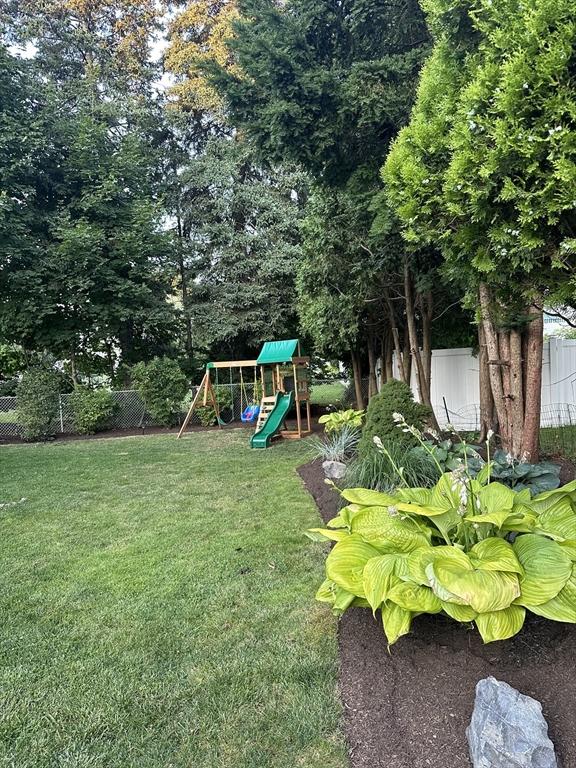 view of yard with a playground and fence