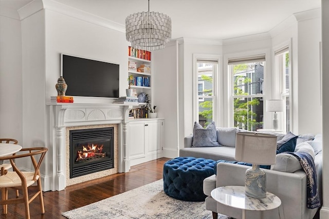 17 Atlantic St, Boston, MA 02127 - living room with wood finished floors, crown molding, a glass covered fireplace, a chandelier, and baseboards