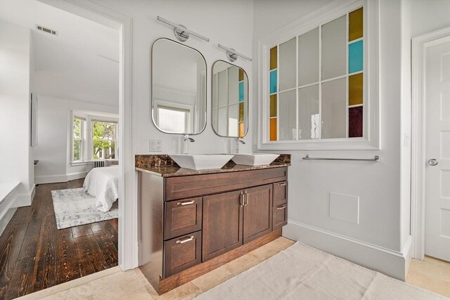 17 Atlantic St, Boston, MA 02127 - bathroom featuring vanity, baseboards, wood finished floors, and ensuite bath