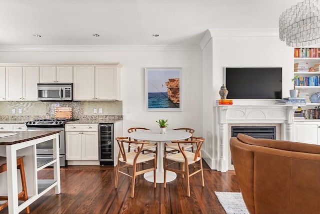 17 Atlantic St, Boston, MA 02127 - kitchen with stainless steel appliances, beverage cooler, open floor plan, decorative backsplash, and crown molding