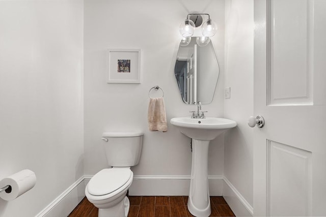 17 Atlantic St, Boston, MA 02127 - half bathroom with wood finish floors, toilet, and baseboards