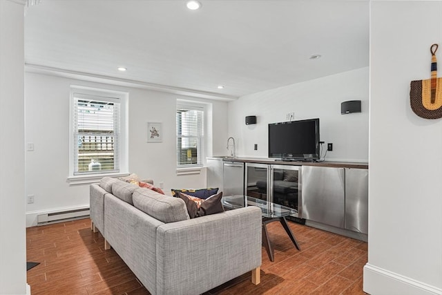 17 Atlantic St, Boston, MA 02127 - living area with a baseboard heating unit, wood finished floors, recessed lighting, and baseboards