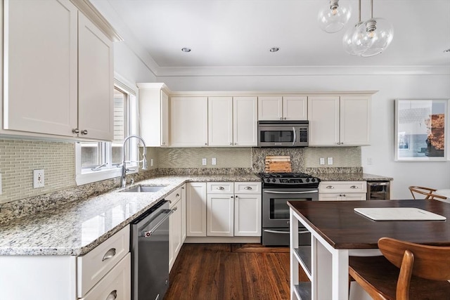 17 Atlantic St, Boston, MA 02127 - kitchen with appliances with stainless steel finishes, a sink, dark wood-style floors, light stone countertops, and white cabinets