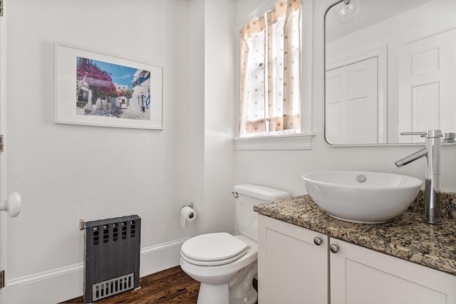 17 Atlantic St, Boston, MA 02127 - bathroom with radiator, vanity, toilet, wood finished floors, and baseboards