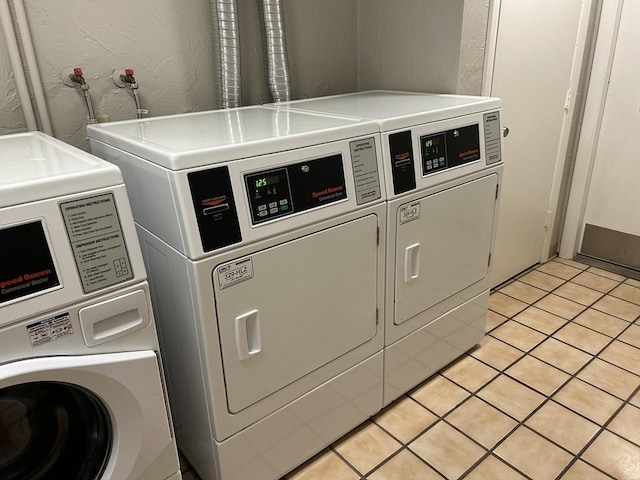188 Swanson Rd Unit 331, Boxborough, MA 01719 - community laundry with washer and clothes dryer, a textured wall, and light tile patterned floors