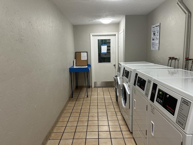 188 Swanson Rd Unit 331, Boxborough, MA 01719 - shared laundry room with washer and clothes dryer, a textured wall, light tile patterned floors, and baseboards