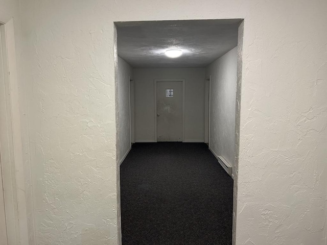 188 Swanson Rd Unit 331, Boxborough, MA 01719 - hall featuring a textured wall, dark colored carpet, a baseboard heating unit, and baseboards
