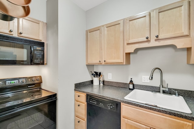 kitchen with black appliances, light brown cabinetry, and sink