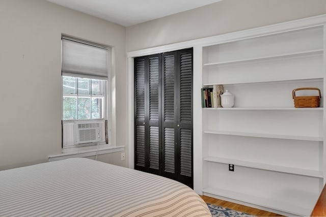 bedroom with wood-type flooring and a closet