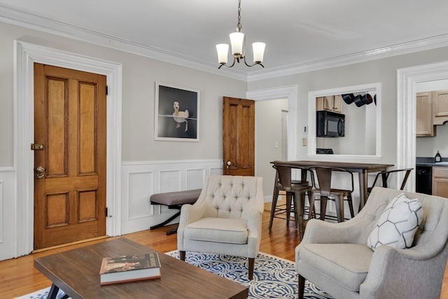 interior space featuring ornamental molding, an inviting chandelier, and light hardwood / wood-style floors