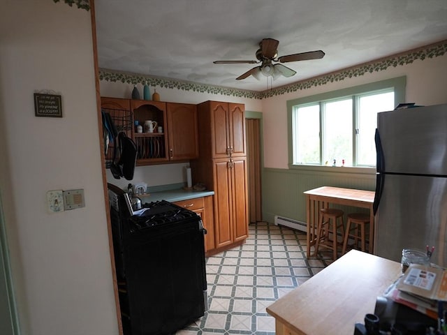 95AKA93 Lynnway, Revere, MA 02151 - kitchen with black gas range, freestanding refrigerator, a ceiling fan, a wainscoted wall, and light flooring