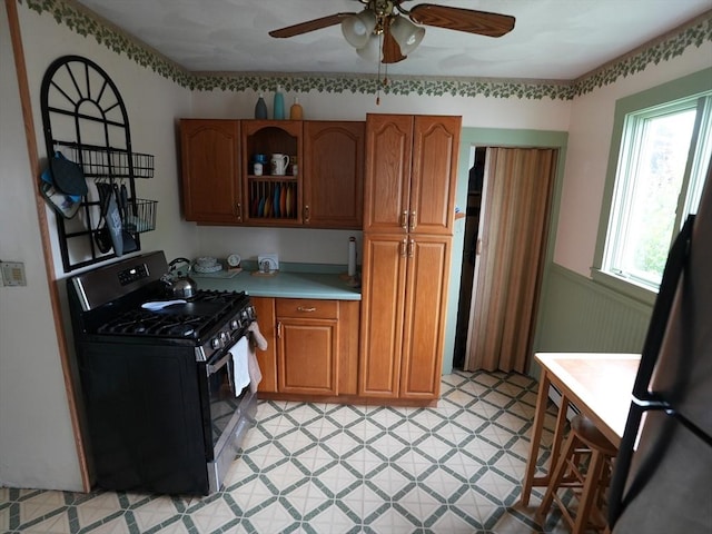 95AKA93 Lynnway, Revere, MA 02151 - kitchen with black gas stove, wainscoting, ceiling fan, light countertops, and light flooring