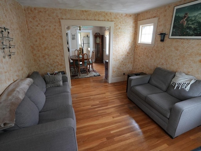 95AKA93 Lynnway, Revere, MA 02151 - living area with light wood finished floors, wallpapered walls, and baseboards
