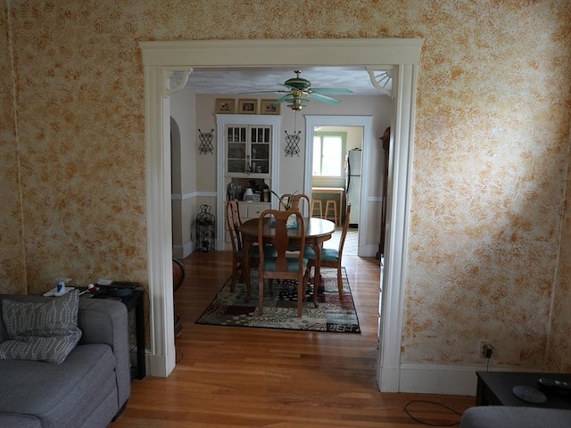 95AKA93 Lynnway, Revere, MA 02151 - dining space featuring wallpapered walls, wood finished floors, a ceiling fan, arched walkways, and baseboards