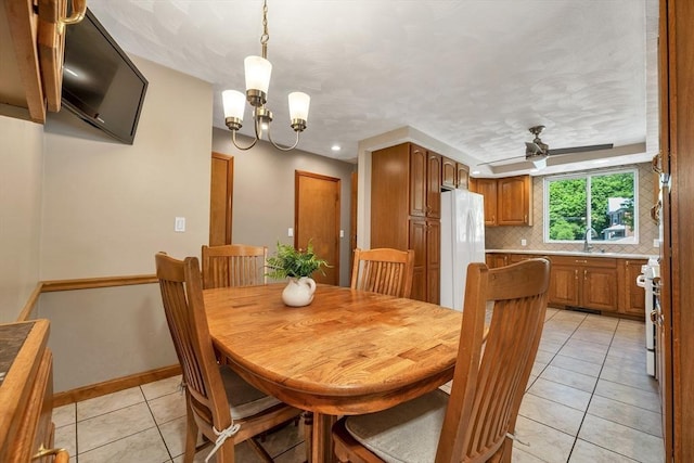dining area featuring light tile patterned floors, a chandelier, a ceiling fan, baseboards, and recessed lighting