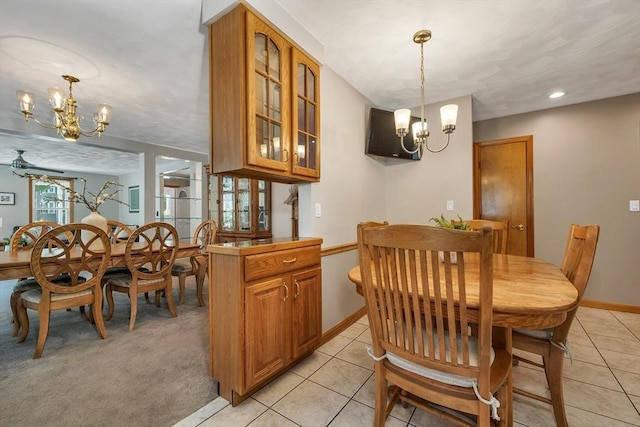 dining space featuring a chandelier, baseboards, and light tile patterned floors