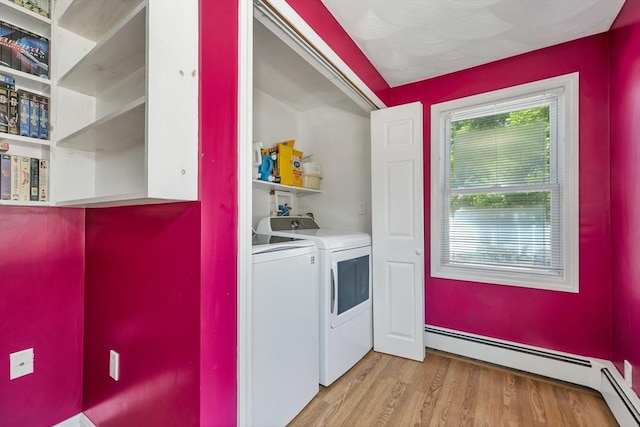 laundry room featuring independent washer and dryer, baseboard heating, and light wood finished floors