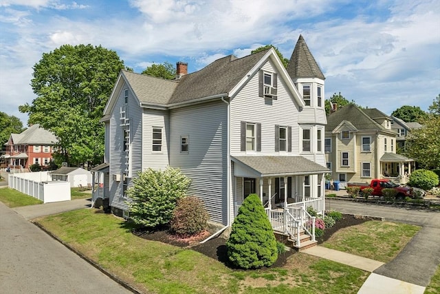 view of front of property featuring covered porch, a chimney, a shingled roof, and a residential view