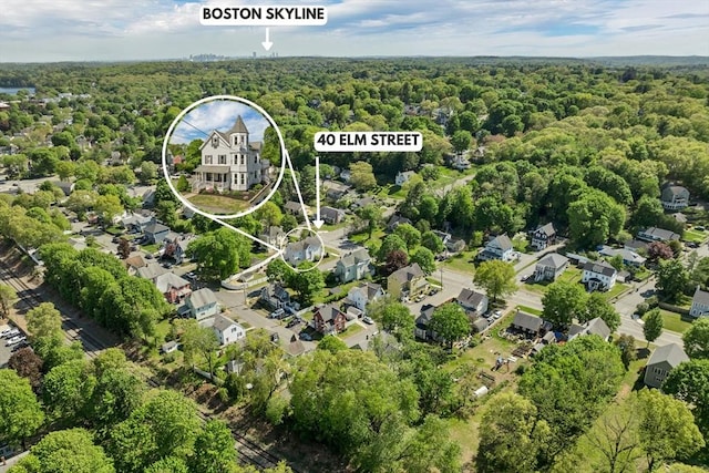 aerial view of property and surrounding area with a forest