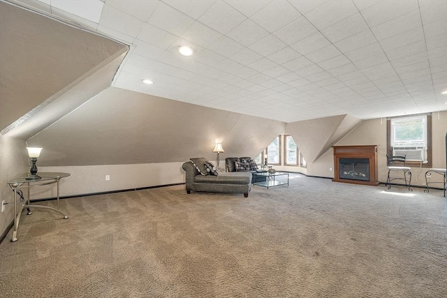 unfurnished room with carpet, lofted ceiling, recessed lighting, baseboards, and cooling unit