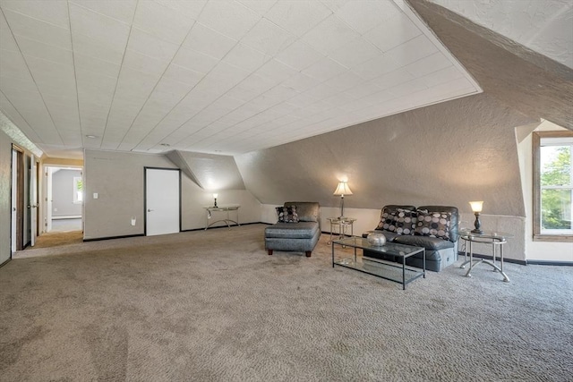 carpeted living room featuring vaulted ceiling
