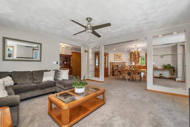 carpeted living room with a chandelier, ceiling fan, baseboards, and recessed lighting