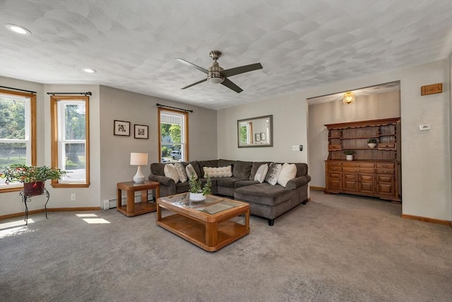 carpeted living area with baseboards, a ceiling fan, recessed lighting, and a baseboard heating unit