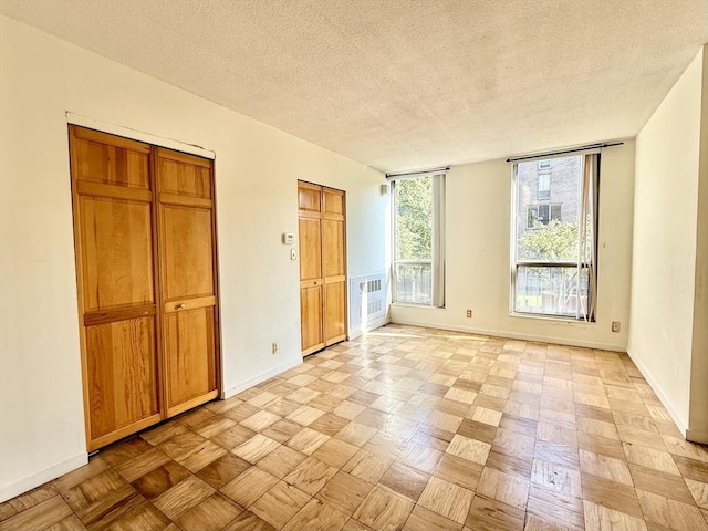 77 Pond Ave Unit 312, Brookline, MA 02445 - unfurnished bedroom with a textured ceiling