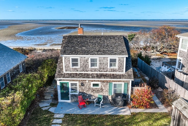 rear view of property with a patio area and a water view