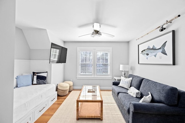 living room with light wood-type flooring and a ceiling fan