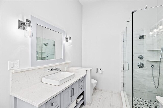 full bathroom with baseboards, toilet, a stall shower, and vanity