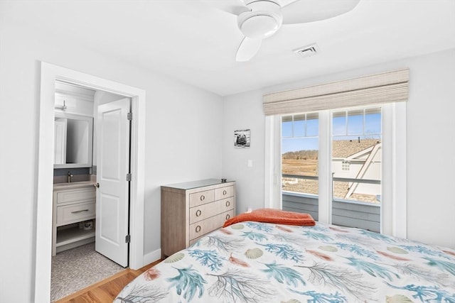 bedroom featuring visible vents, ceiling fan, light wood-style flooring, ensuite bathroom, and access to outside