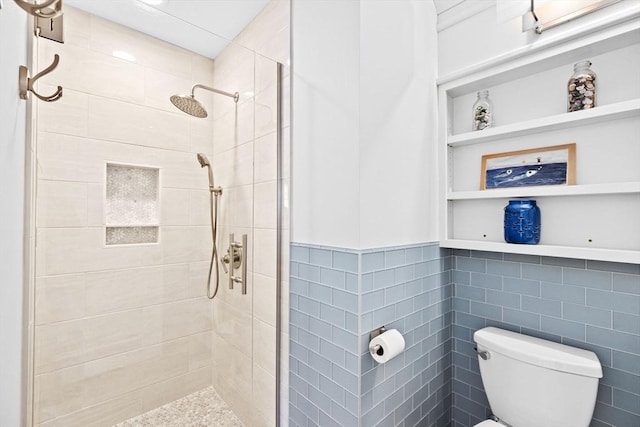 full bath with tile walls, toilet, a stall shower, and built in features