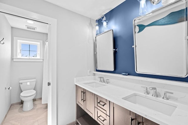bathroom with toilet, baseboards, visible vents, and a sink