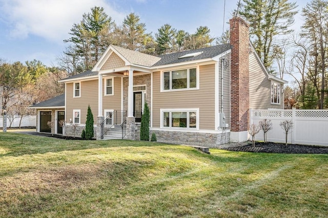 split foyer home with a front lawn