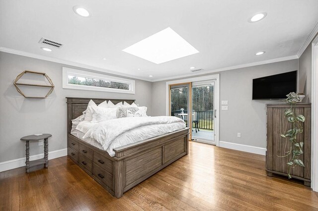 bedroom with a skylight, access to outside, hardwood / wood-style flooring, and ornamental molding