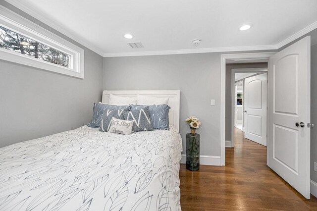 bedroom with hardwood / wood-style flooring and crown molding