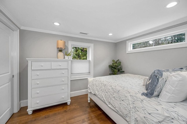 bedroom with crown molding and dark hardwood / wood-style floors